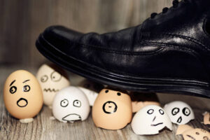 Abstract Composition Of Business Leadership. Broken Eggs Under Mans Shoes.